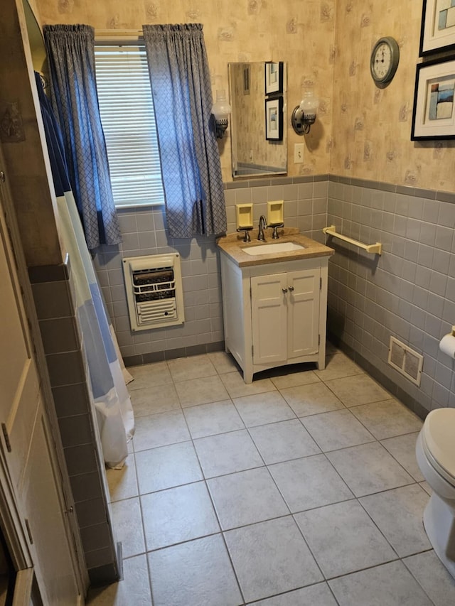521 E Allen St, Lancaster, OH 43130 - bathroom featuring heating unit, tile walls, tile patterned floors, wainscoting, and vanity