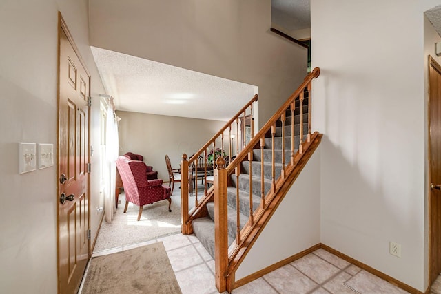 4224 Eagle Head Dr, Columbus, OH 43230 - staircase featuring a textured ceiling and baseboards