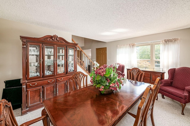 4224 Eagle Head Dr, Columbus, OH 43230 - dining room featuring light colored carpet, a textured ceiling, and stairs