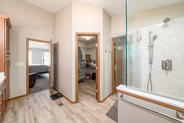 4224 Eagle Head Dr, Columbus, OH 43230 - ensuite bathroom with a marble finish shower, vanity, wood finished floors, a walk in closet, and a textured ceiling