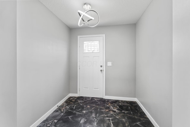 1612 Cole St, Columbus, OH 43205 - entryway featuring dark marble finish floors and a textured ceiling