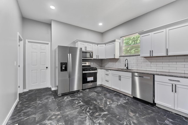 1612 Cole St, Columbus, OH 43205 - kitchen featuring stainless steel appliances, dark marble finish flooring, tasteful backsplash, white cabinets, and dark stone counters