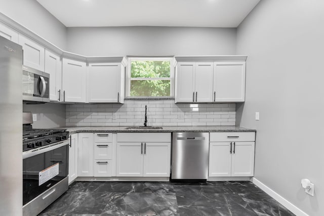 1612 Cole St, Columbus, OH 43205 - kitchen with stainless steel appliances, dark marble finish floors, backsplash, and stone counters