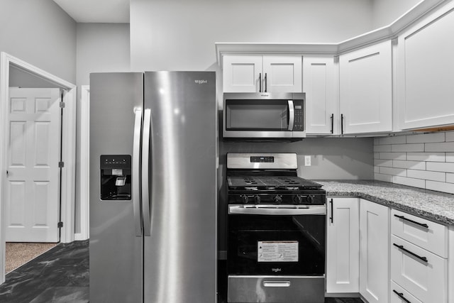 1612 Cole St, Columbus, OH 43205 - kitchen with appliances with stainless steel finishes, white cabinetry, and decorative backsplash