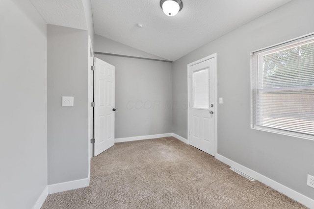 1612 Cole St, Columbus, OH 43205 - carpeted empty room with lofted ceiling and a textured ceiling