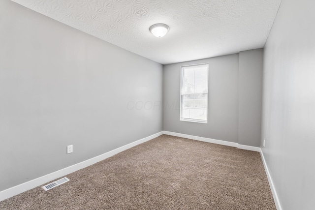 1612 Cole St, Columbus, OH 43205 - empty room with carpet and a textured ceiling