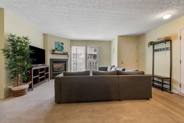4109 Blendon Way Dr Unit 99E, Columbus, OH 43230 - living area with a glass covered fireplace, light carpet, and a textured ceiling