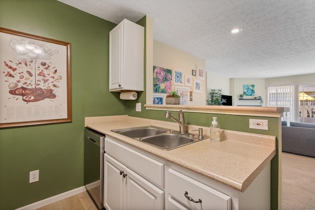 4109 Blendon Way Dr Unit 99E, Columbus, OH 43230 - kitchen featuring open floor plan, dishwasher, a textured ceiling, white cabinets, and a peninsula