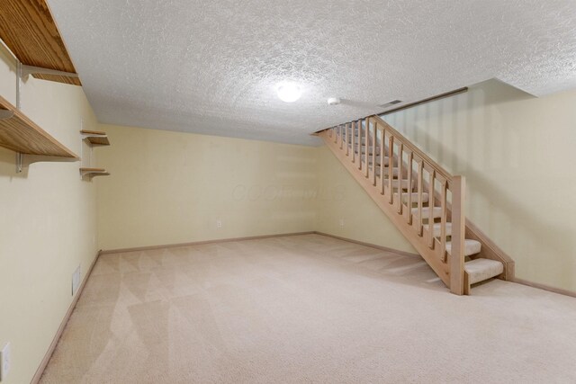 4109 Blendon Way Dr Unit 99E, Columbus, OH 43230 - finished basement with stairway, a textured ceiling, and carpet flooring