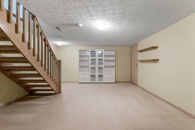 4109 Blendon Way Dr Unit 99E, Columbus, OH 43230 - finished below grade area featuring a textured ceiling, stairway, and light colored carpet