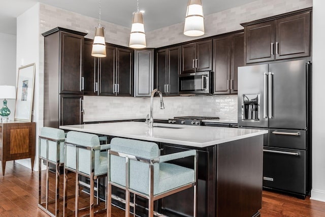 250 W Spring St Unit 626, Columbus, OH 43215 - kitchen featuring high end fridge, stainless steel microwave, dark wood-type flooring, light countertops, and decorative light fixtures