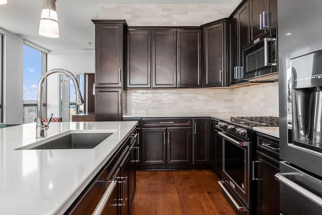 250 W Spring St Unit 626, Columbus, OH 43215 - kitchen featuring stainless steel appliances, dark wood-style flooring, light countertops, and backsplash