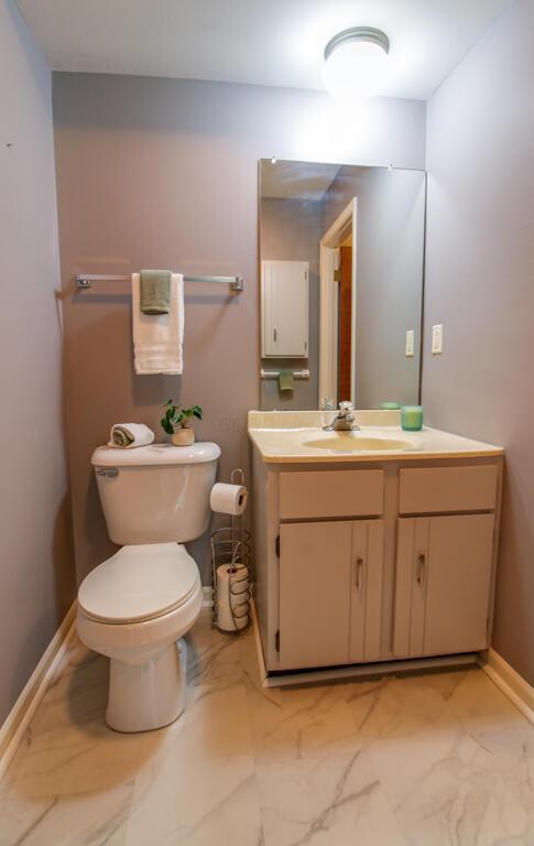 1206 Crescent Heights Rd, Marion, OH 43302 - half bath with marble look tile flooring and vanity