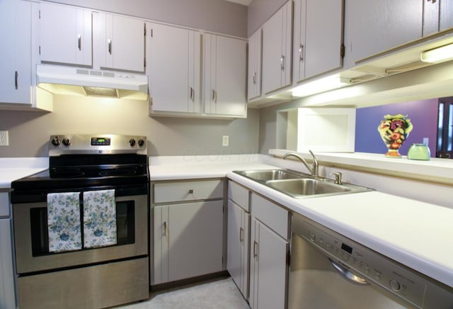 1206 Crescent Heights Rd, Marion, OH 43302 - kitchen with appliances with stainless steel finishes, under cabinet range hood, light countertops, and white cabinetry
