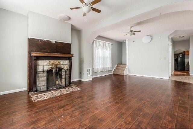 1364 E Fulton St, Columbus, OH 43205 - unfurnished living room with a ceiling fan, arched walkways, wood finished floors, and a fireplace