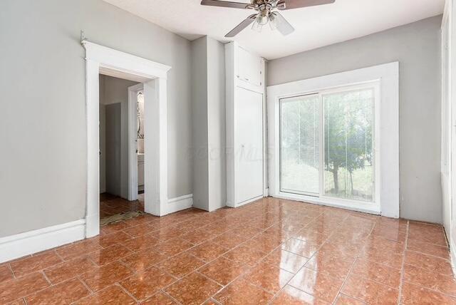 1364 E Fulton St, Columbus, OH 43205 - spare room featuring a ceiling fan and tile patterned floors