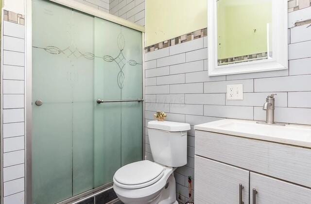 1364 E Fulton St, Columbus, OH 43205 - bathroom featuring tile walls, vanity, and a stall shower