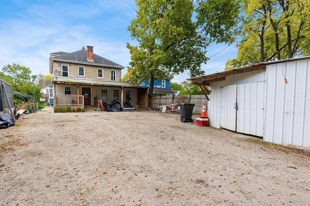 1364 E Fulton St, Columbus, OH 43205 - back of house with a chimney, covered porch, and an outbuilding