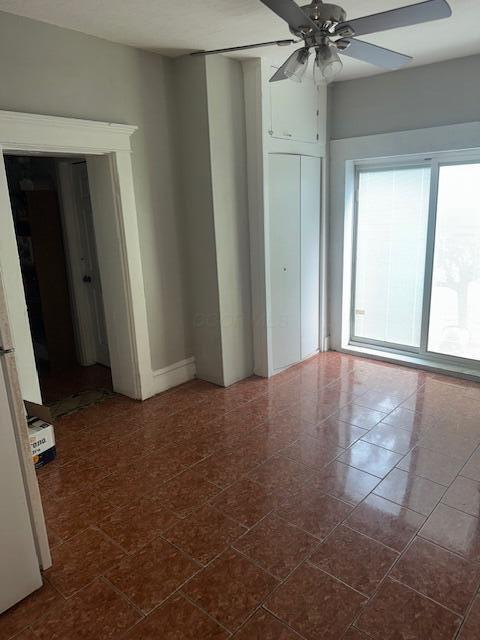 1364 E Fulton St, Columbus, OH 43205 - spare room with ceiling fan and dark tile patterned floors