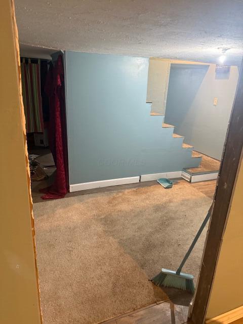 1364 E Fulton St, Columbus, OH 43205 - stairway with a textured ceiling and carpet flooring