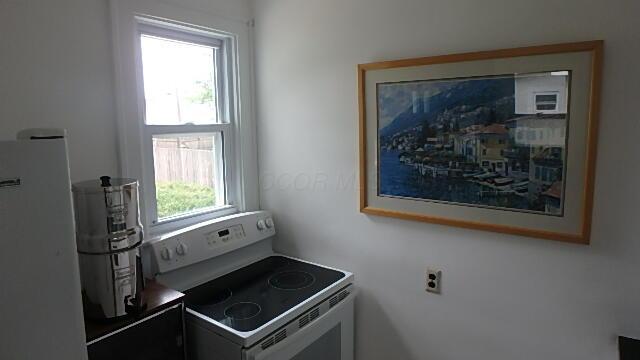 1483 Elmwood Ave, Columbus, OH 43212 - kitchen with white range with electric stovetop and refrigerator