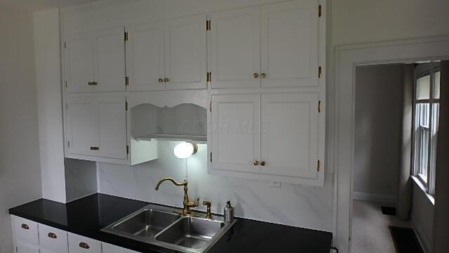 1483 Elmwood Ave, Columbus, OH 43212 - kitchen with dark countertops and white cabinets