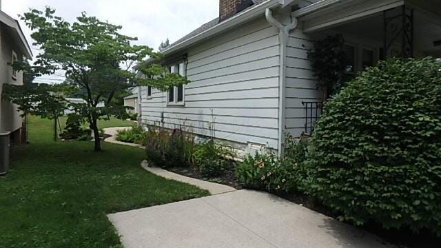 1483 Elmwood Ave, Columbus, OH 43212 - view of property exterior with a chimney, a lawn, and a patio
