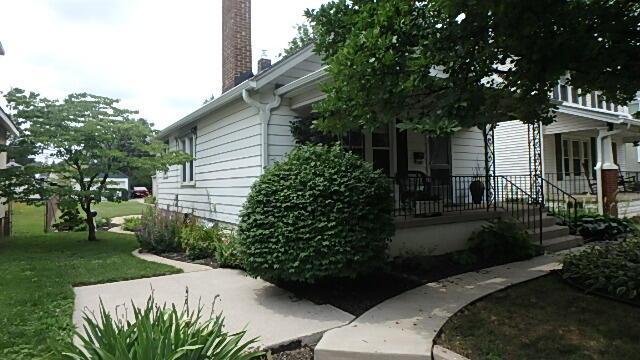 1483 Elmwood Ave, Columbus, OH 43212 - view of side of home with a chimney, covered porch, and a lawn