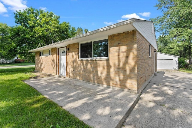1556 Vilardo Ln, Columbus, OH 43227 - single story home with a front yard, brick siding, an outbuilding, and a detached garage