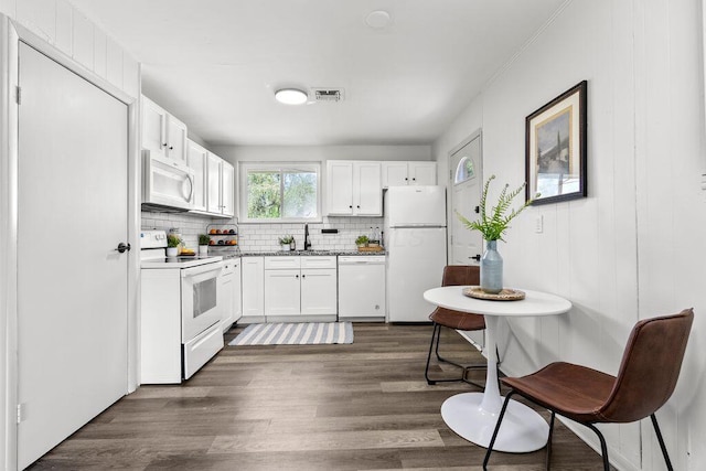 1556 Vilardo Ln, Columbus, OH 43227 - kitchen with white appliances, dark wood-type flooring, tasteful backsplash, and white cabinetry