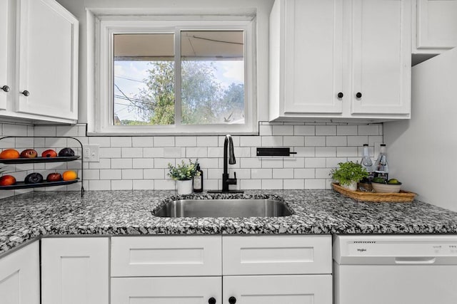 1556 Vilardo Ln, Columbus, OH 43227 - kitchen with white dishwasher, white cabinetry, backsplash, and dark stone countertops