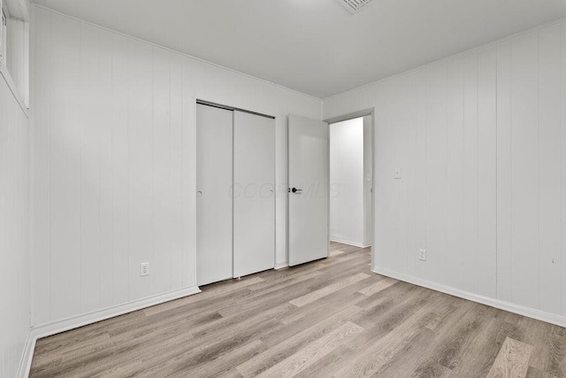1556 Vilardo Ln, Columbus, OH 43227 - unfurnished bedroom featuring wood finished floors and a closet