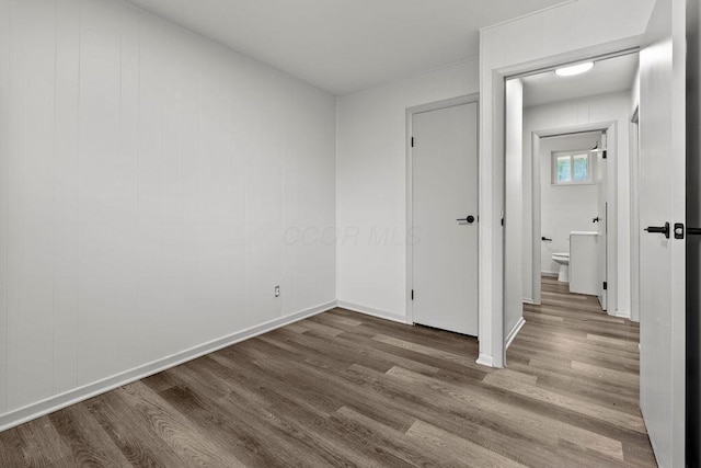 1556 Vilardo Ln, Columbus, OH 43227 - unfurnished bedroom featuring dark wood-style flooring and baseboards