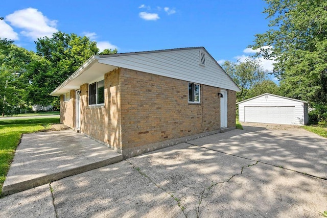 1556 Vilardo Ln, Columbus, OH 43227 - view of side of property featuring an outbuilding, a detached garage, and brick siding