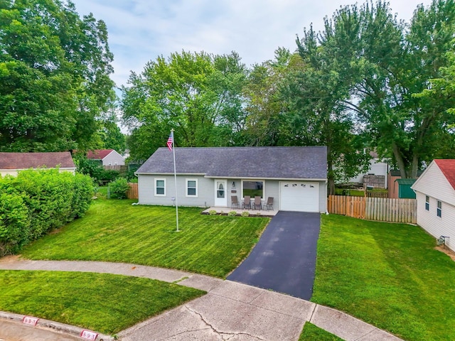 893 Aladdin Ct, Columbus, OH 43207 - view of front of house featuring a garage, asphalt driveway, and a porch
