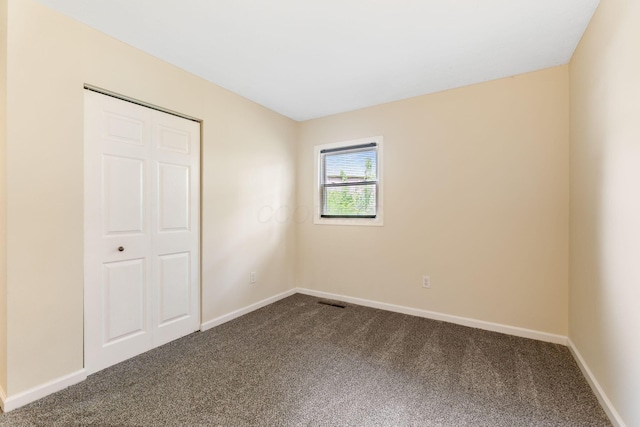 893 Aladdin Ct, Columbus, OH 43207 - unfurnished bedroom featuring dark colored carpet and a closet