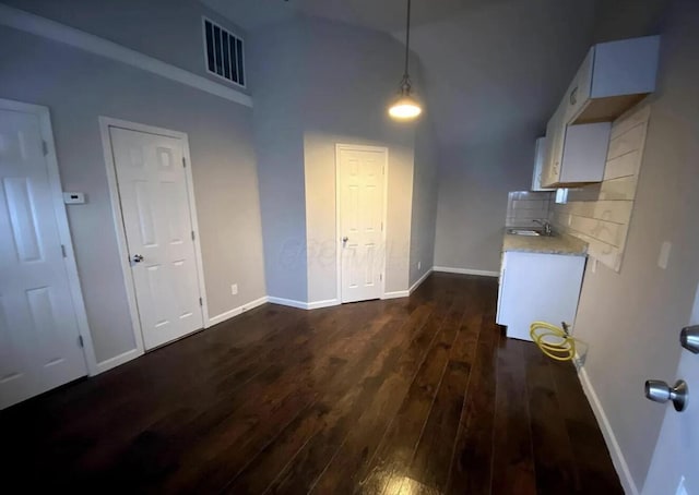 1555 Myrtle Ave, Columbus, OH 43211 - unfurnished dining area with dark wood-type flooring and a high ceiling