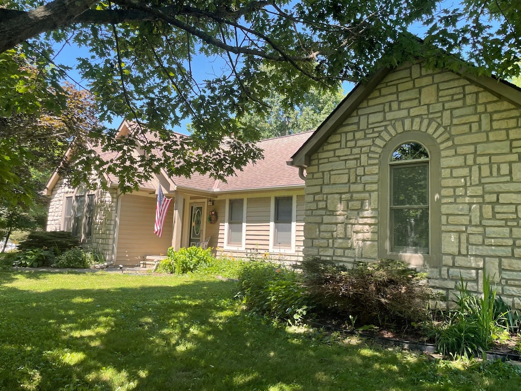 4114 Hardscrabble Rd, Alexandria, OH 43001 - view of front of home featuring stone siding, a front yard, and a shingled roof