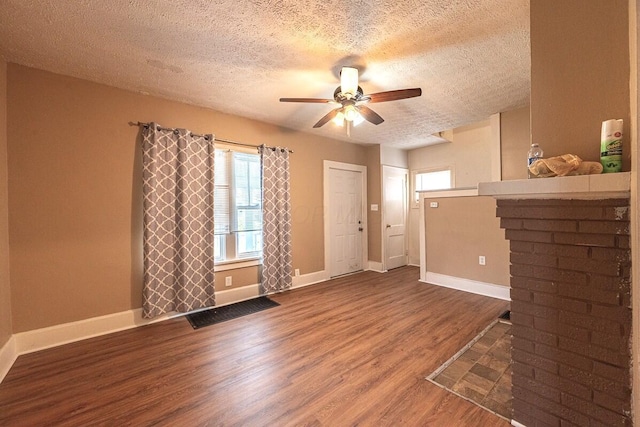 330 S Harris Ave, Columbus, OH 43204 - unfurnished living room featuring a textured ceiling, wood finished floors, and ceiling fan