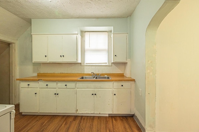 330 S Harris Ave, Columbus, OH 43204 - kitchen with wood finished floors, range, arched walkways, tasteful backsplash, and a textured ceiling