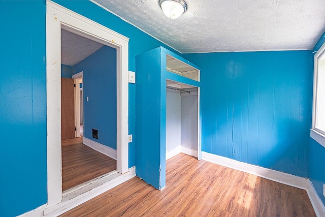 330 S Harris Ave, Columbus, OH 43204 - unfurnished bedroom with a textured ceiling, wood finished floors, and a closet