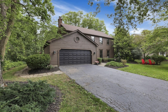 1100 Riva Ridge Blvd, Columbus, OH 43230 - colonial inspired home featuring a garage, driveway, a chimney, and a front yard