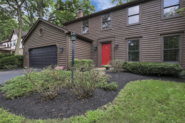 1100 Riva Ridge Blvd, Columbus, OH 43230 - view of front of property featuring a chimney, an attached garage, and driveway