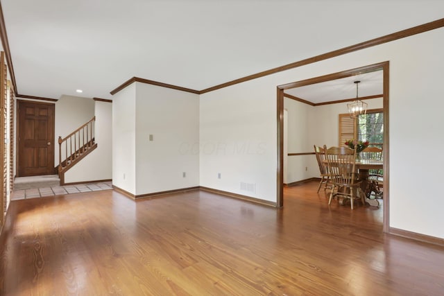 1100 Riva Ridge Blvd, Columbus, OH 43230 - unfurnished living room with wood finished floors, ornamental molding, stairway, and a chandelier