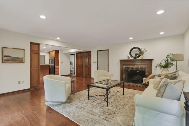 1100 Riva Ridge Blvd, Columbus, OH 43230 - living area with dark wood finished floors, a brick fireplace, and recessed lighting