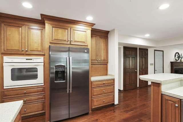 1100 Riva Ridge Blvd, Columbus, OH 43230 - kitchen with stainless steel refrigerator with ice dispenser, white oven, light countertops, dark wood-style floors, and recessed lighting