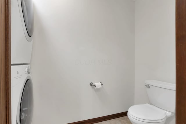 1100 Riva Ridge Blvd, Columbus, OH 43230 - bathroom featuring stacked washing machine and dryer and tile patterned flooring