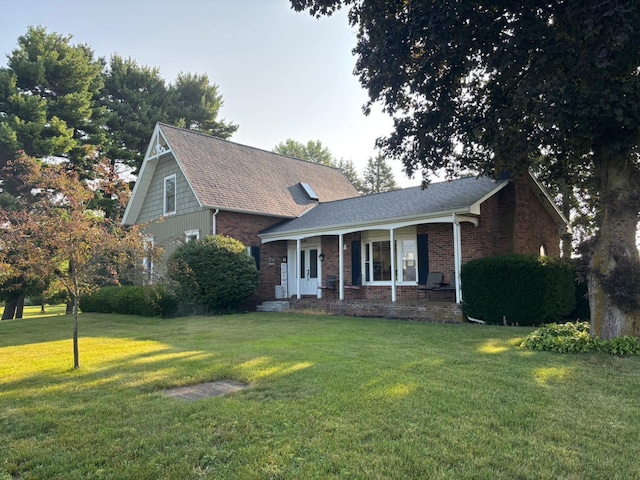 3688 Gooding Rd, Marion, OH 43302 - view of front of property with a front yard, brick siding, roof with shingles, and a porch