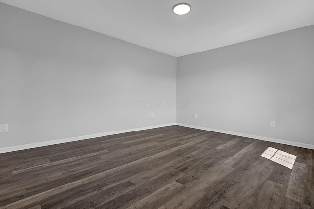 406 Aarika Dr, West Jefferson, OH 43162 - unfurnished room with baseboards and dark wood-type flooring