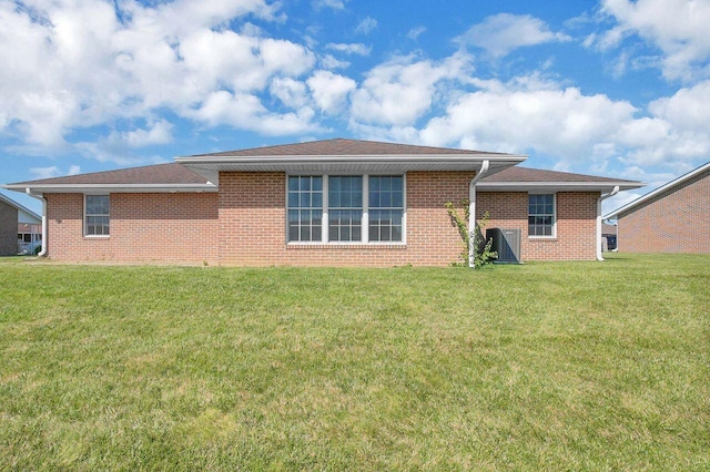 406 Aarika Dr, West Jefferson, OH 43162 - rear view of house featuring a yard and brick siding